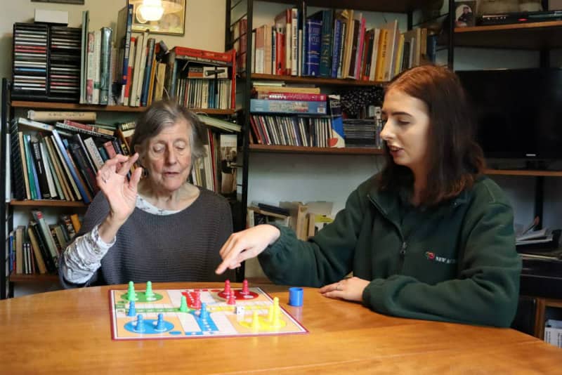 Carer playing a board game with a client