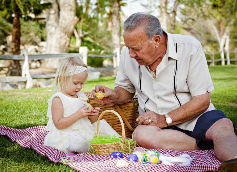 elderly man with grand daughter easter egg hunt