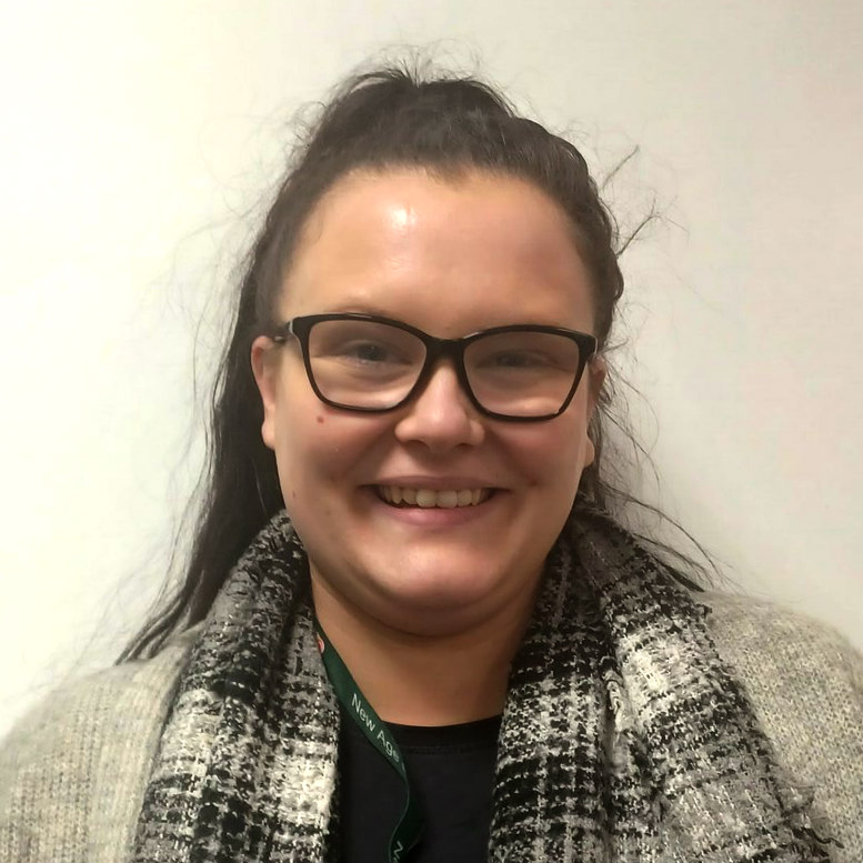 Smiling woman with glasses wearing scarf