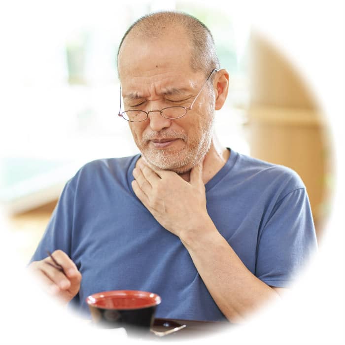 Senior man feeling unwell, holding throat and bowl