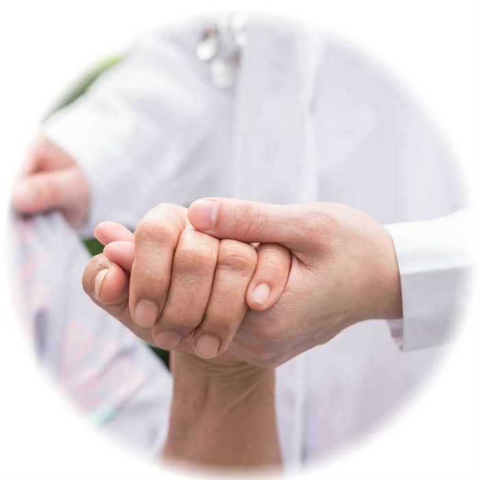 Close-up of doctor's hands clasped warmly