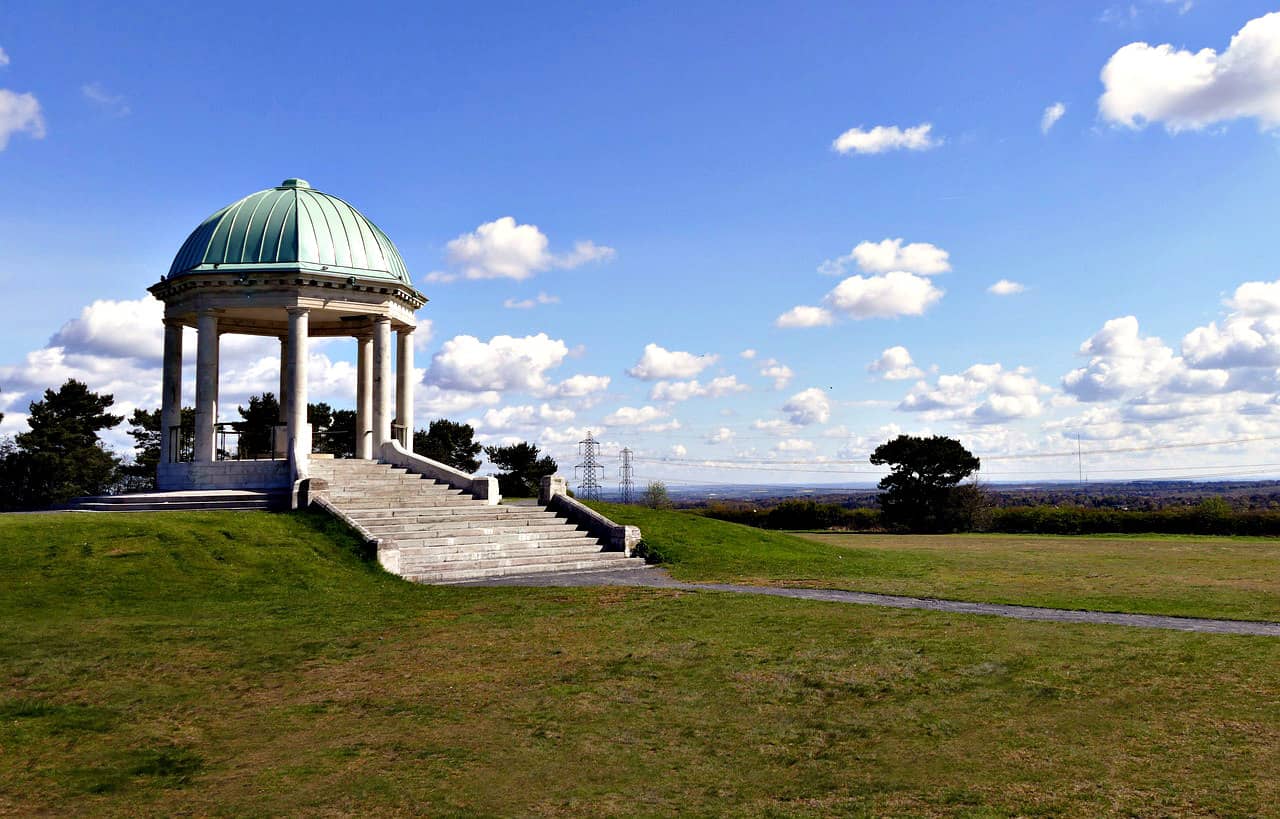 Green landscape with classical dome structure on hilltop