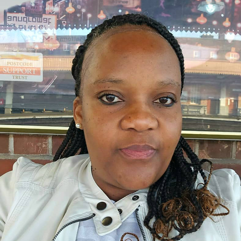 Woman with braids sitting at cafe