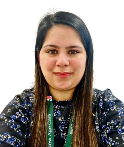 Woman in floral top with New Age Care lanyard